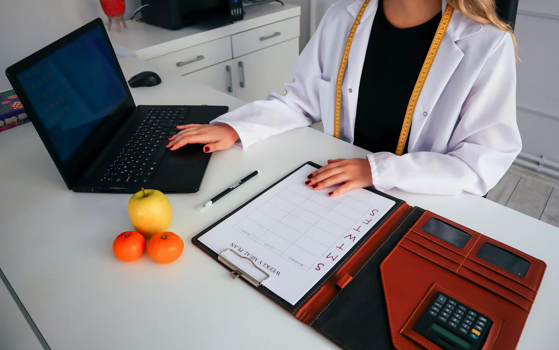 a woman in white coat sitting at the table